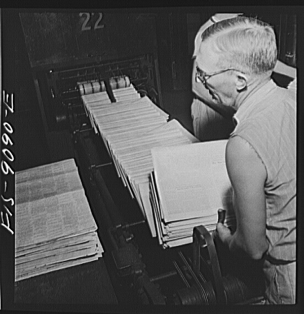 New York, New York. Mailroom of the New York Times newspaper. Papers come from the pressroom on a conveyor